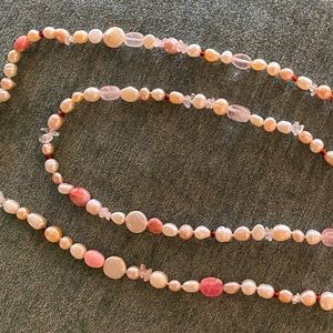 Hi it’s cultured pearls - pink/white/clear - multi-colored 19inch necklace